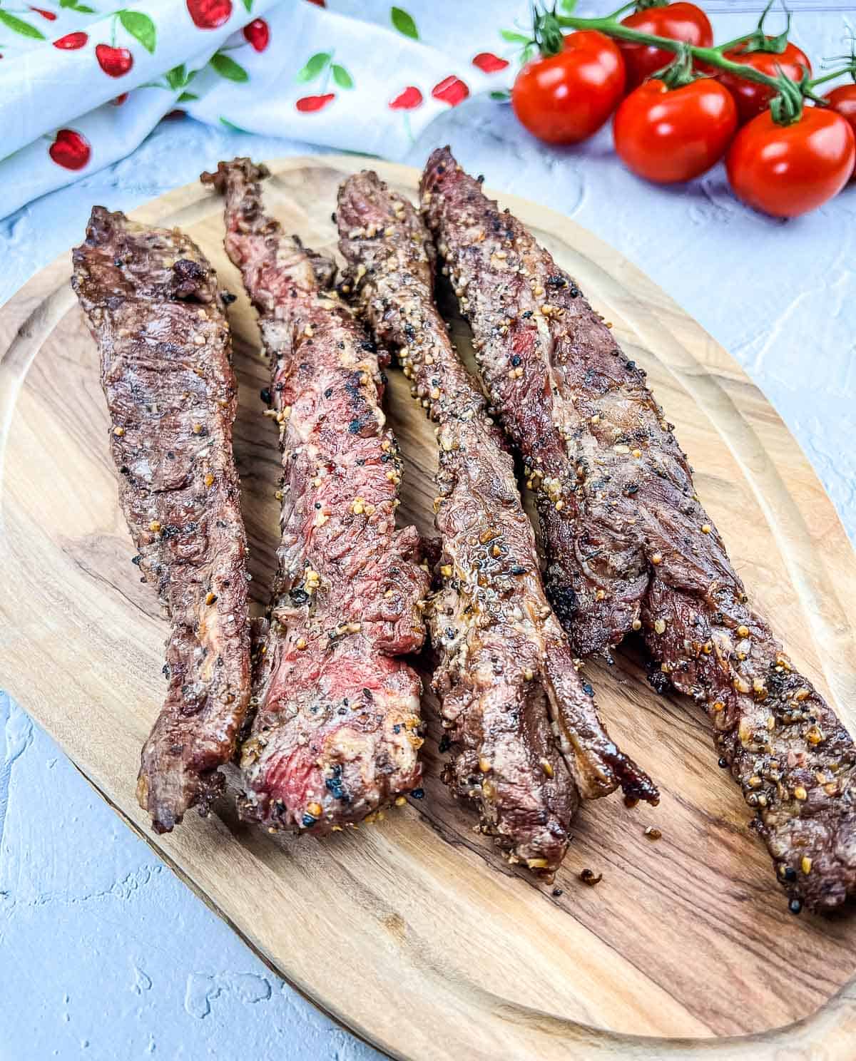 Grilled Beef Finger Meat on a cutting board.