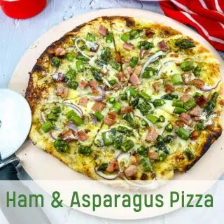 Ham & Asparagus pizza on a pizza stone.