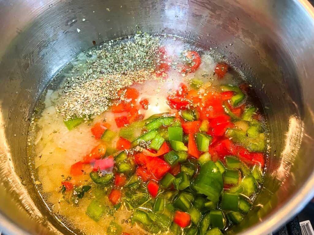 Rice, water, and remaining ingredients in the saucepan to cook the rice.