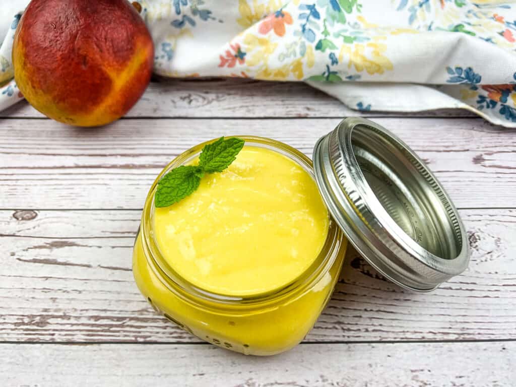 Mango curd in a jar with a lid.