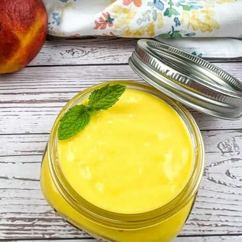 Mango curd in a jar with a lid.
