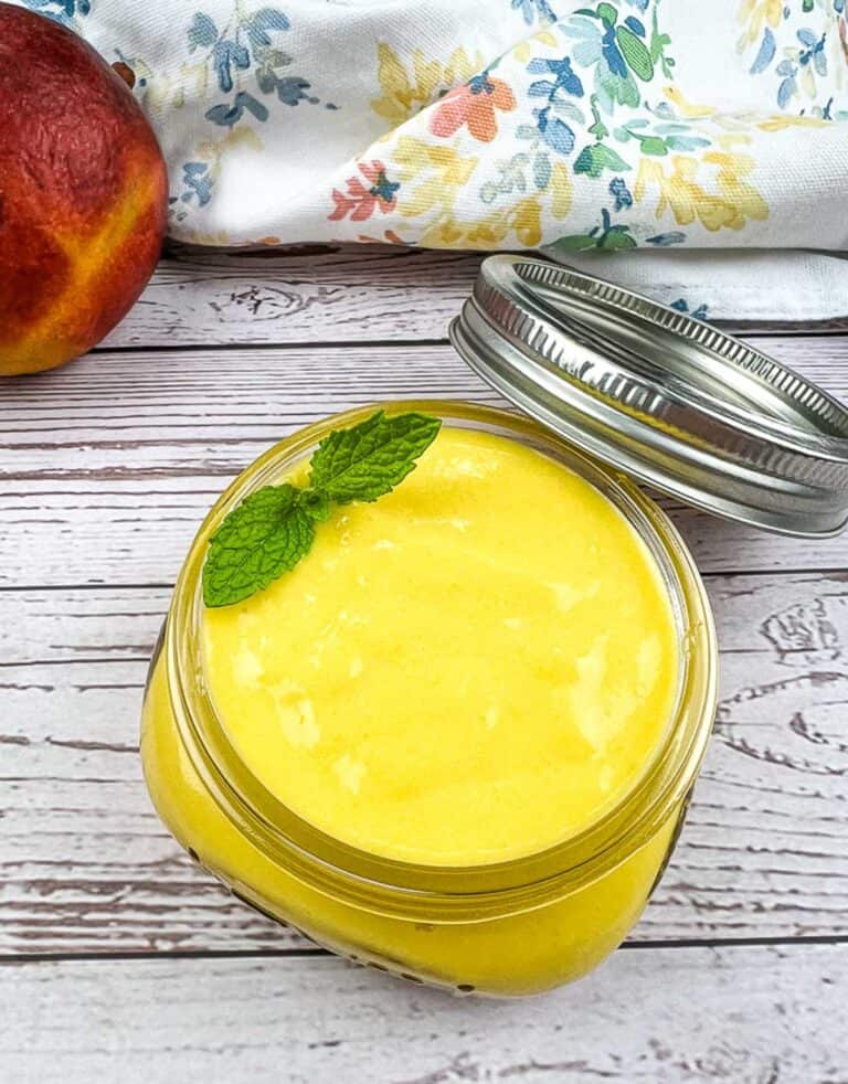 Mango curd in a jar with a lid.