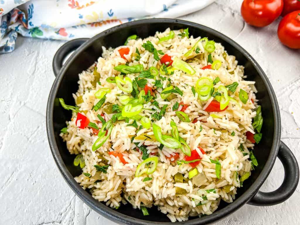 Finished Mediterranean Rice recipe in a black serving bowl.