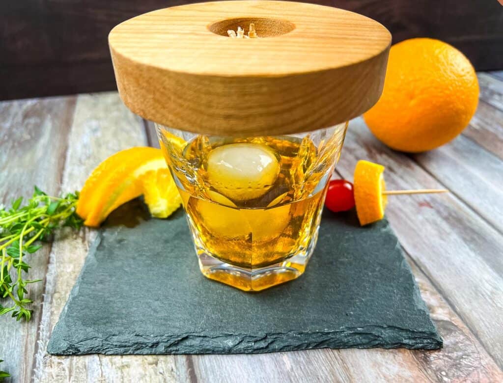 Wooden plate on top of the cocktail.