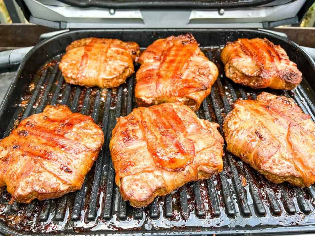 Cooked Bacon-wrapped burgers on the Ninja woodfire grill.