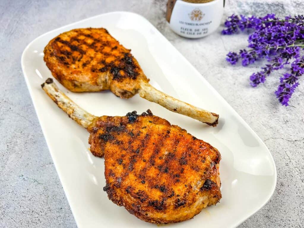 Grilled Pork Tomahawk Chops on a white plate.