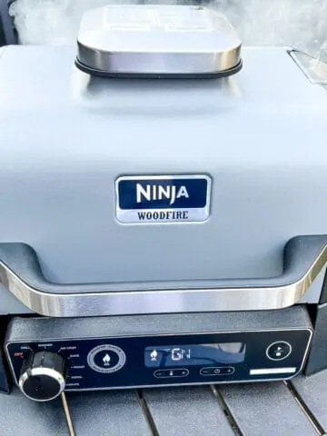 An image of a closed Ninja Woodfire Grill with smoke setting on.