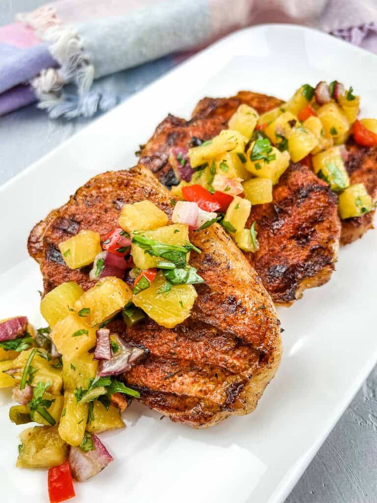 Ninja Woodfire Grill Pork Chops with Pineapple Salsa on a white plate.