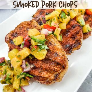 Ninja Woodfire Grilled pork chops with pineapple salsa on a white platter.