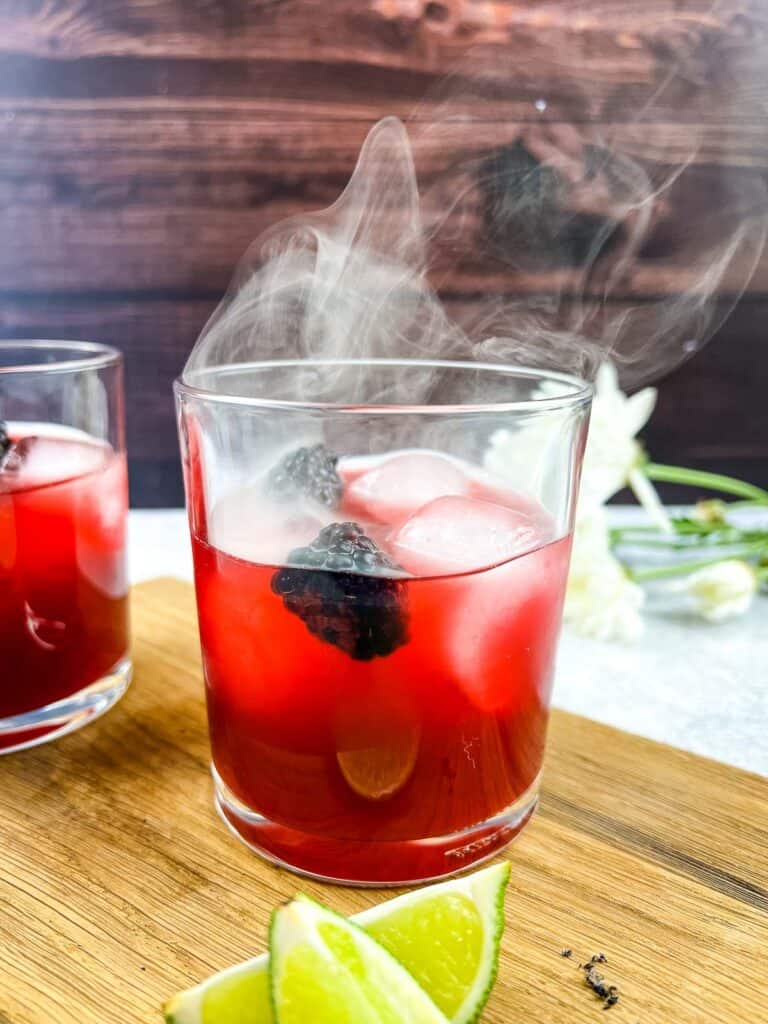 Smoked Blackberry Margarita in a glass with a second cocktail behind.