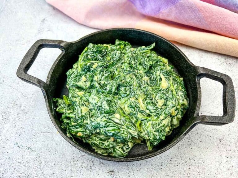 Finished Creamed Spinach with Mascarpone in a black dish.