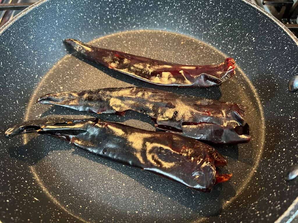 Toasting the guajillo chiles in a dry skillet.
