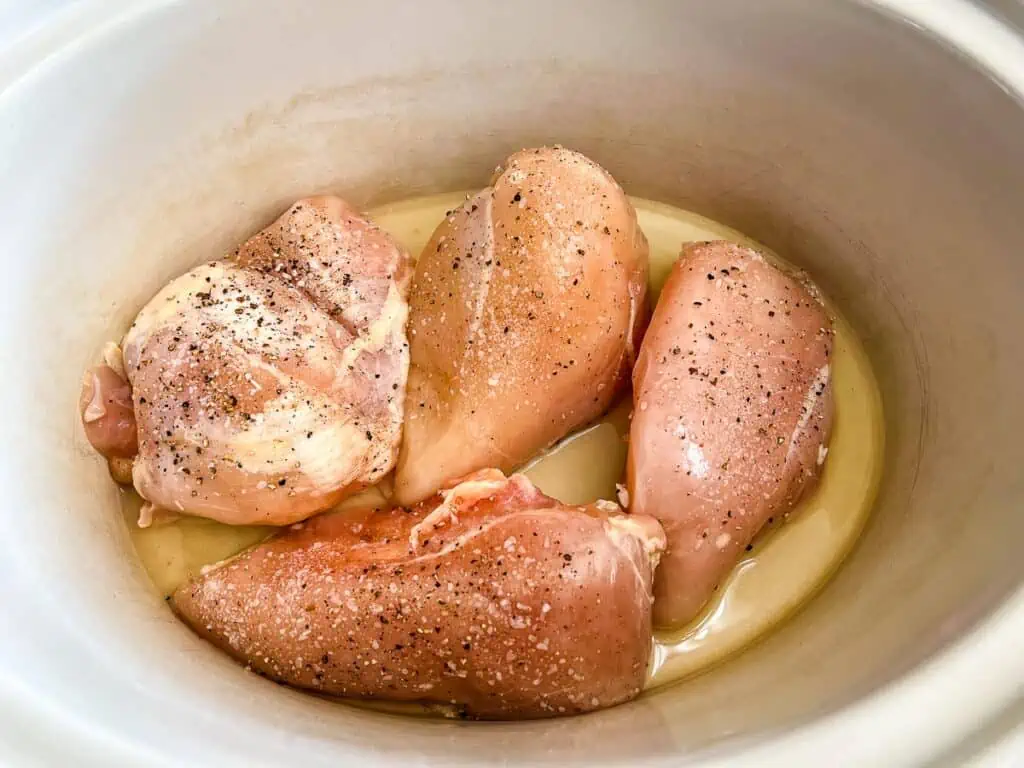 Seasoned chicken breasts in the slow cooker.