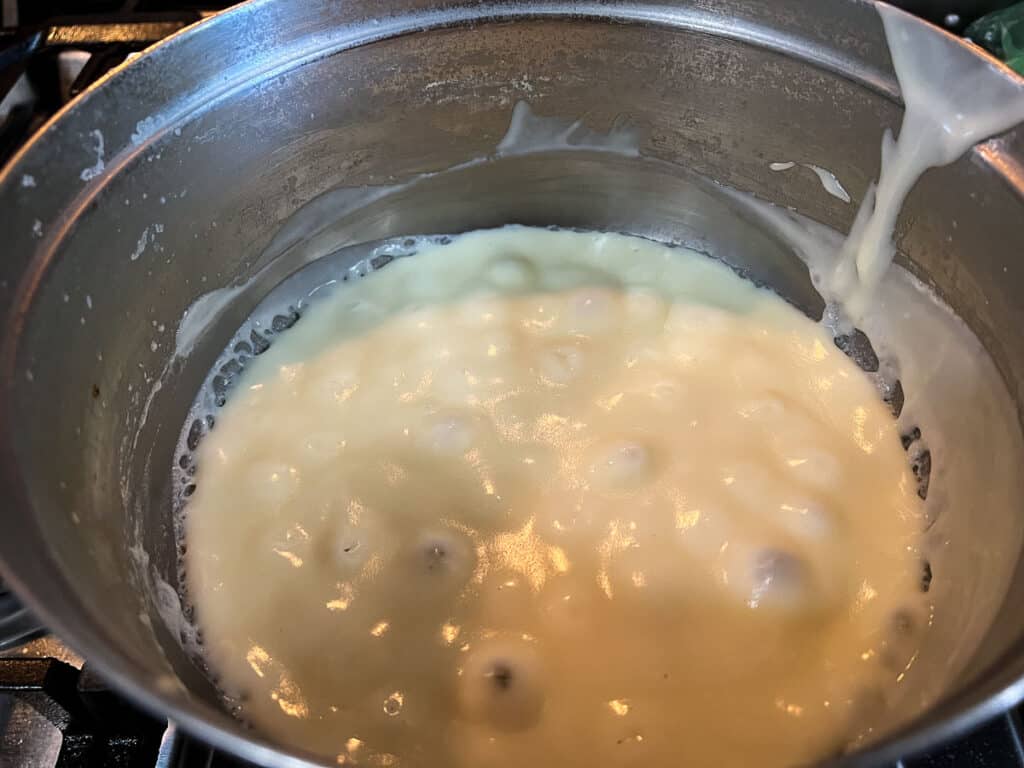Thick and creamy white sauce in a pot.