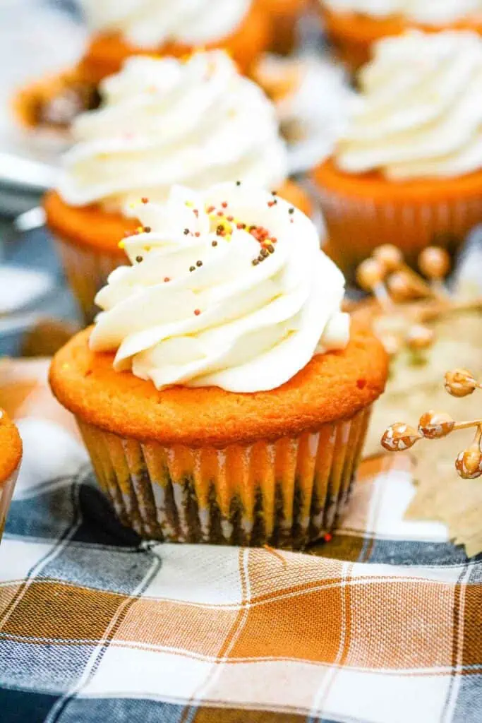 Fall Brownie Cupcakes on a cloth with more in the background.