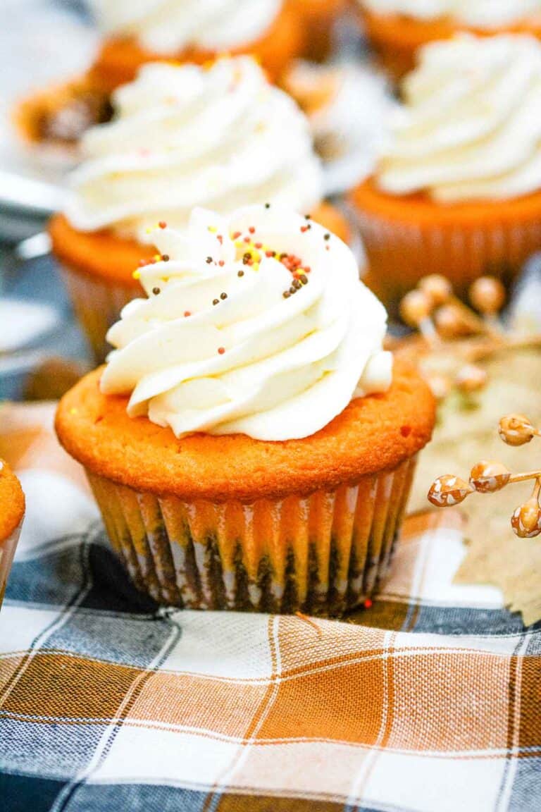 Fall Brownie Cupcakes on a cloth with more in the background.
