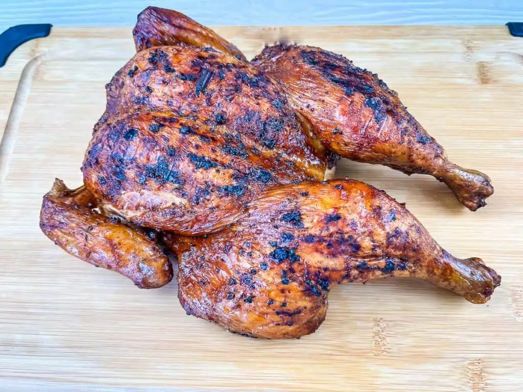 Ninja Woodfire Grill Smoky Whole Chicken on a cutting board.