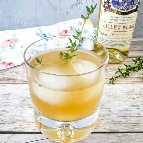 Sunday in the Park Cocktail with a bottle of Lillet Blanc in the background.
