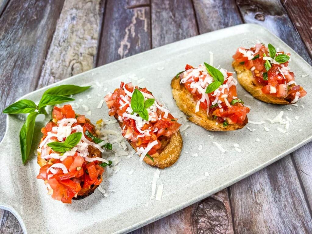 A horizontal shot of tomato bruschetta on a platter.