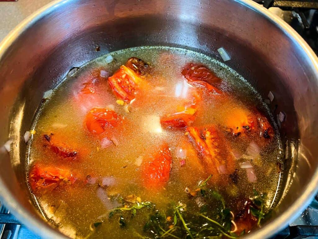 Smoked tomatoes added to the soup pot with the remaining ingredients.