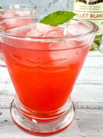 Strawberry-Lillet Crush in a glass with mint.