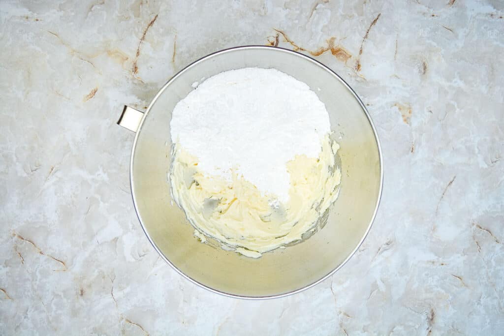 Whipped butter with icing sugar in a bowl.