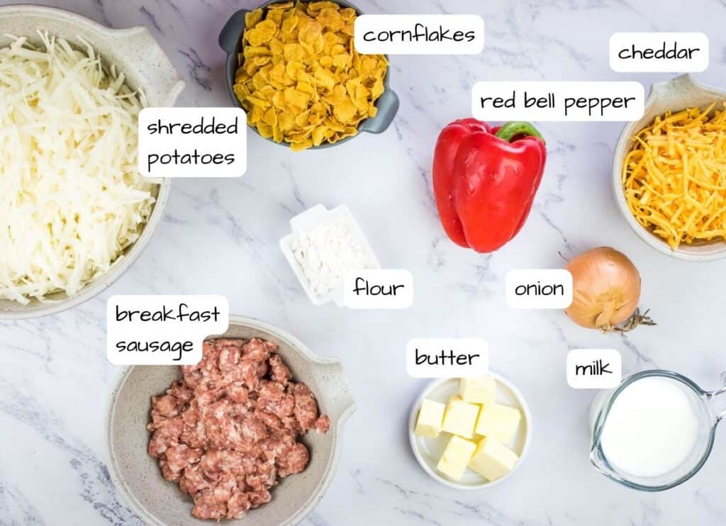 Eggless breakfast casserole ingredients on a marble countertop.
