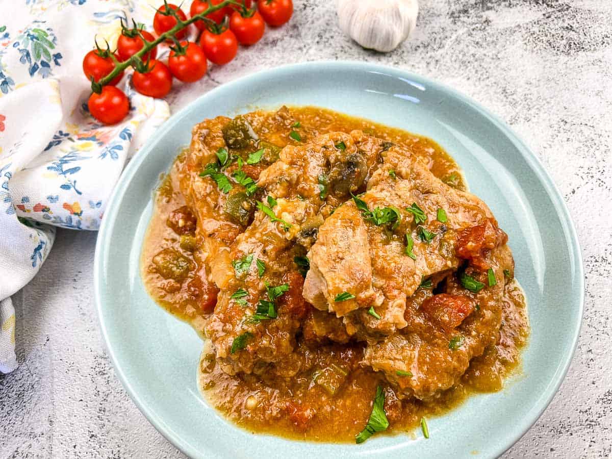 Slow Cooker Swiss Pork Chops on a baby blue serving dish.