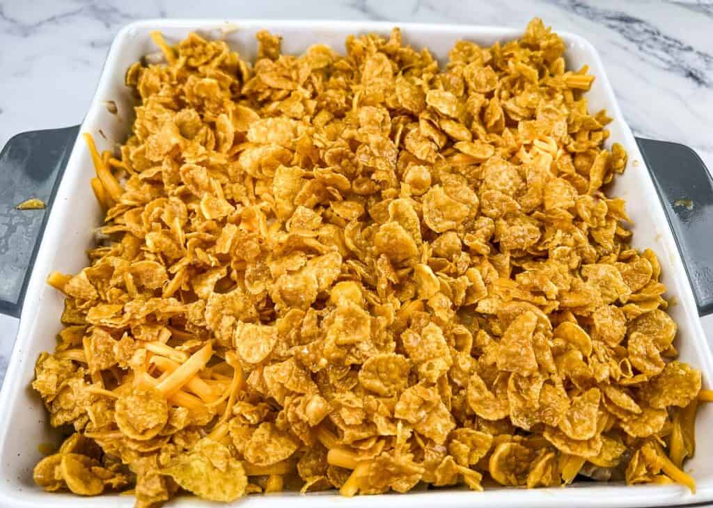 Eggless Breakfast Casserole topped with buttered corn flakes ready for the oven.