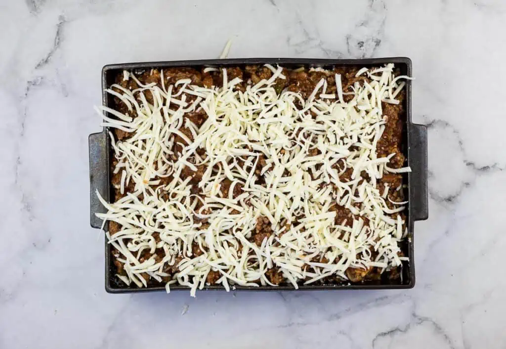 A casserole dish with cheese on top.