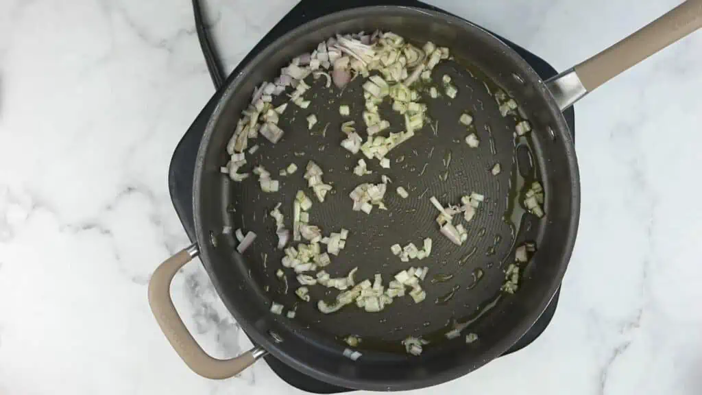 A frying pan with and garlic in it