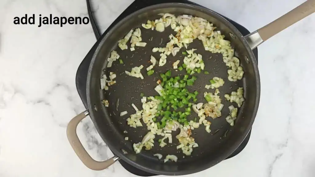 A pan with onions and jalapenos in it.