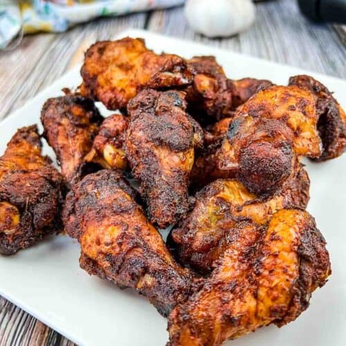 Smoked Dry Rubbed Chicken Wings on a white plate.