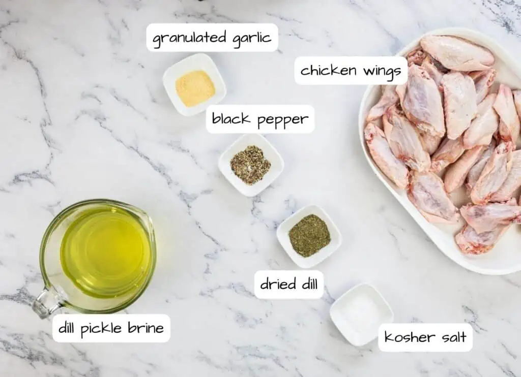 Chicken wings ingredients on a marble countertop.