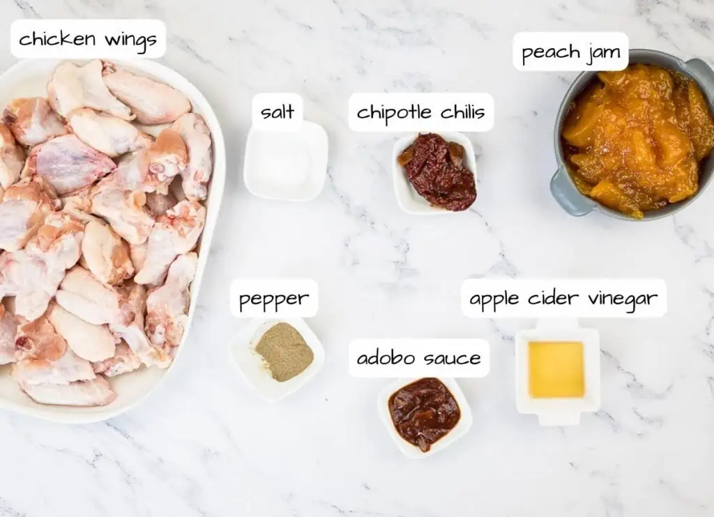 Chicken wings ingredients on a marble table.