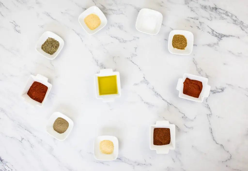 Spices in a circle on a marble table.