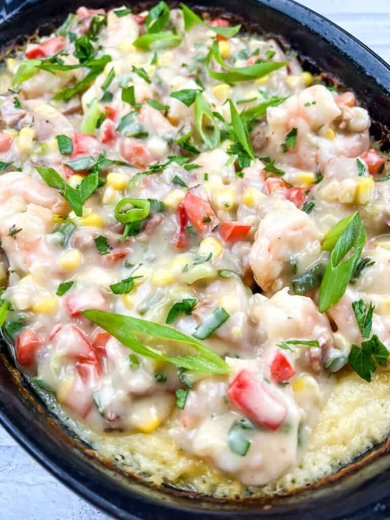 Shrimp and grits casserole in a cast iron skillet.