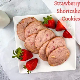 Strawberry shortcake cookies on a white plate.