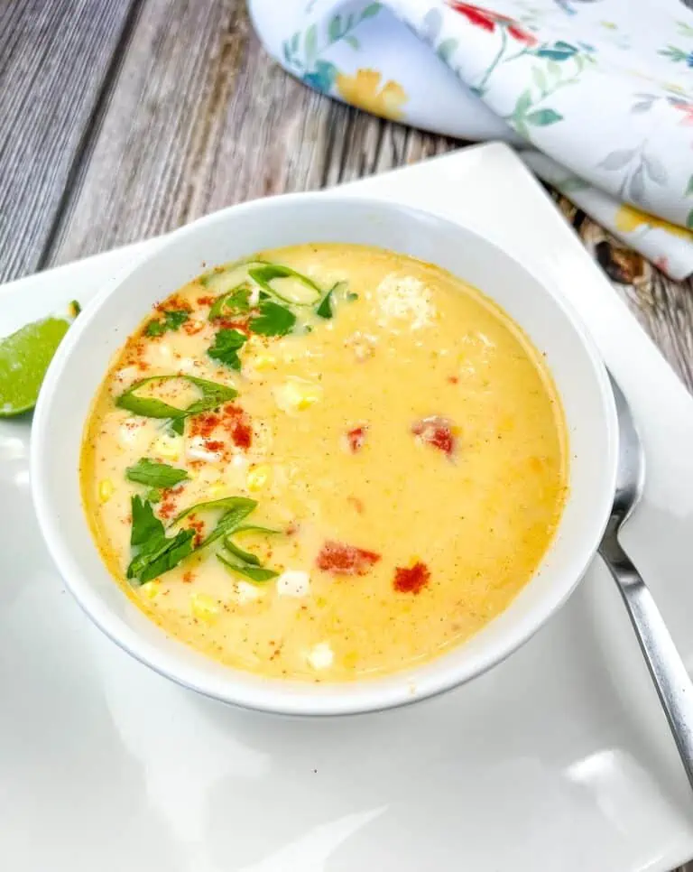 A bowl of Street Corn Soup on a white plate.