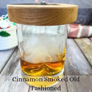 Cinnamon smoked old fashioned in a glass.