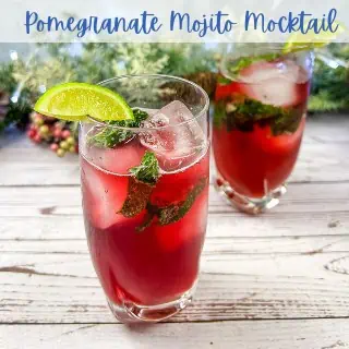 Two glasses of pomegranate mojito mocktail with lime and mint.