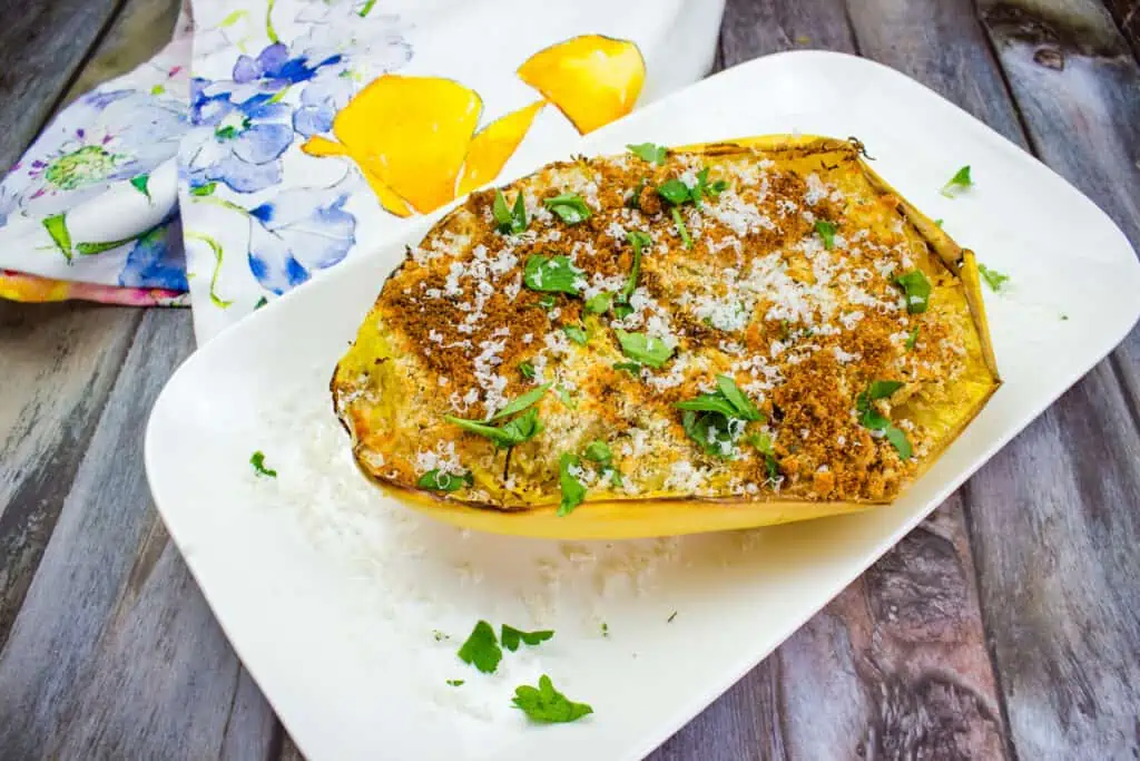 A stuffed squash on a white plate with rice.