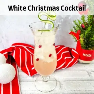 A white christmas cocktail with cranberries and limes.