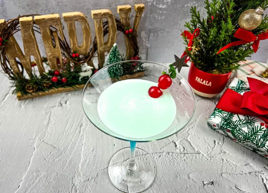 A blue martini with a cherry on top.