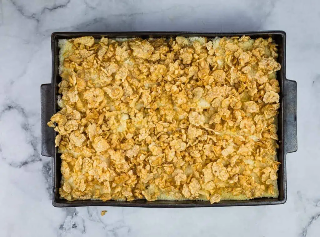 A casserole dish with a layer of crumbs on top.