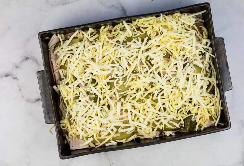 A baking dish with cheese and meat on it.