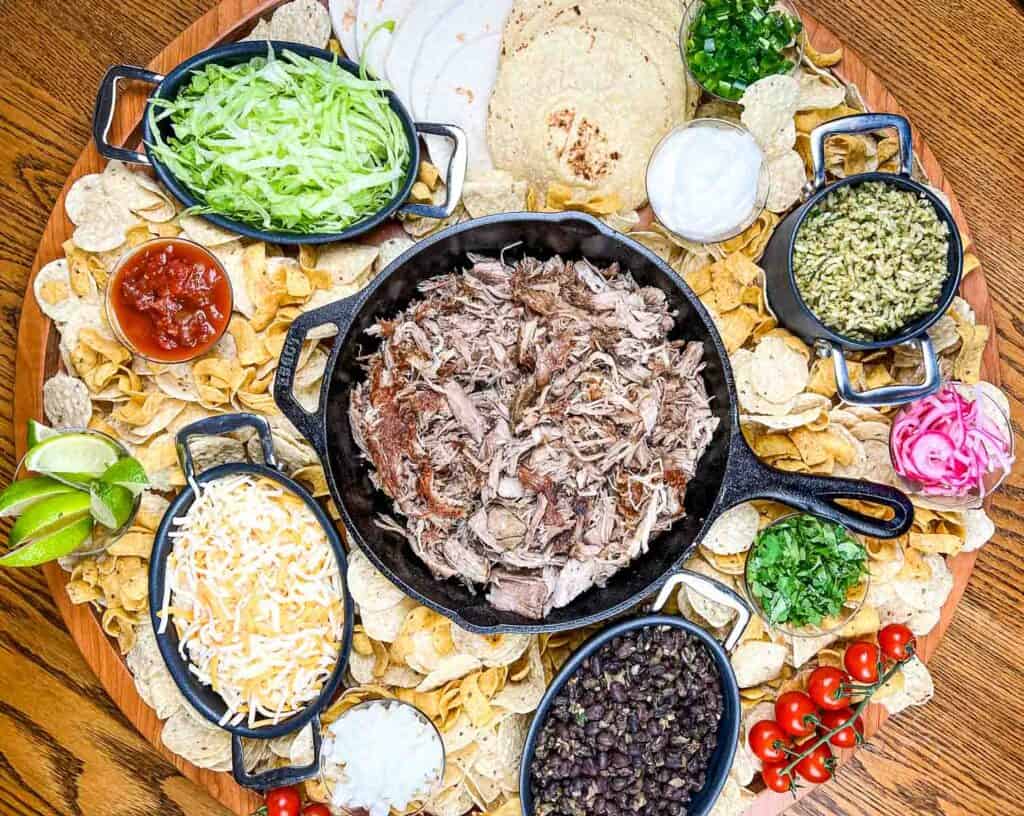 A platter of mexican food on a wooden table.