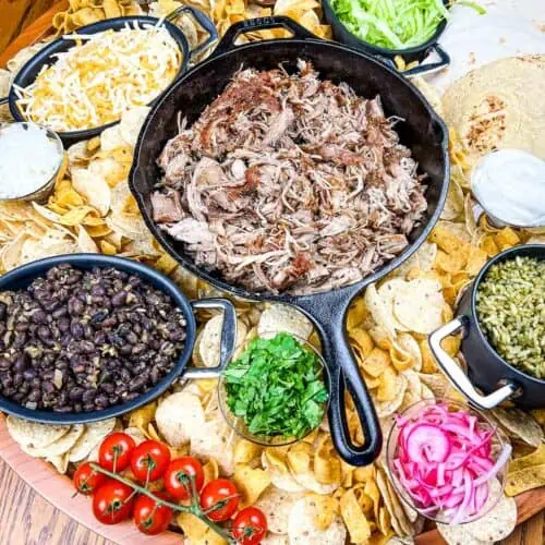 A platter of mexican food on a wooden table.