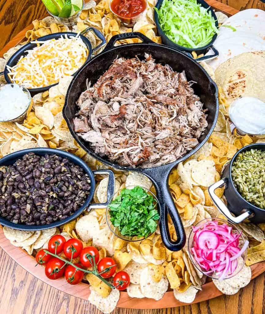 A platter of mexican food on a wooden table.