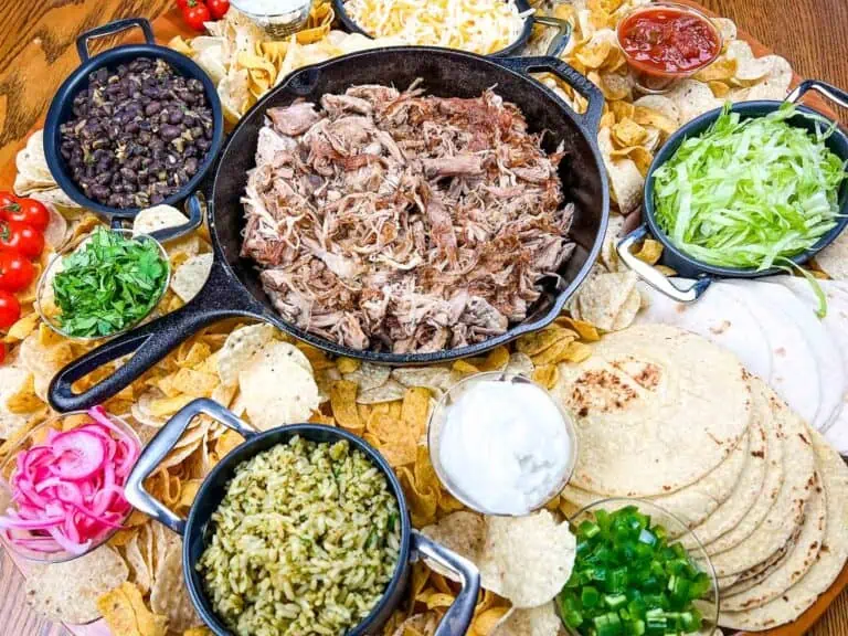A platter of mexican food on a wooden table.